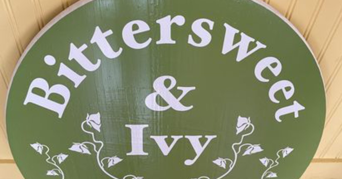 Close-up of green Bittersweet & Ivy Sign 