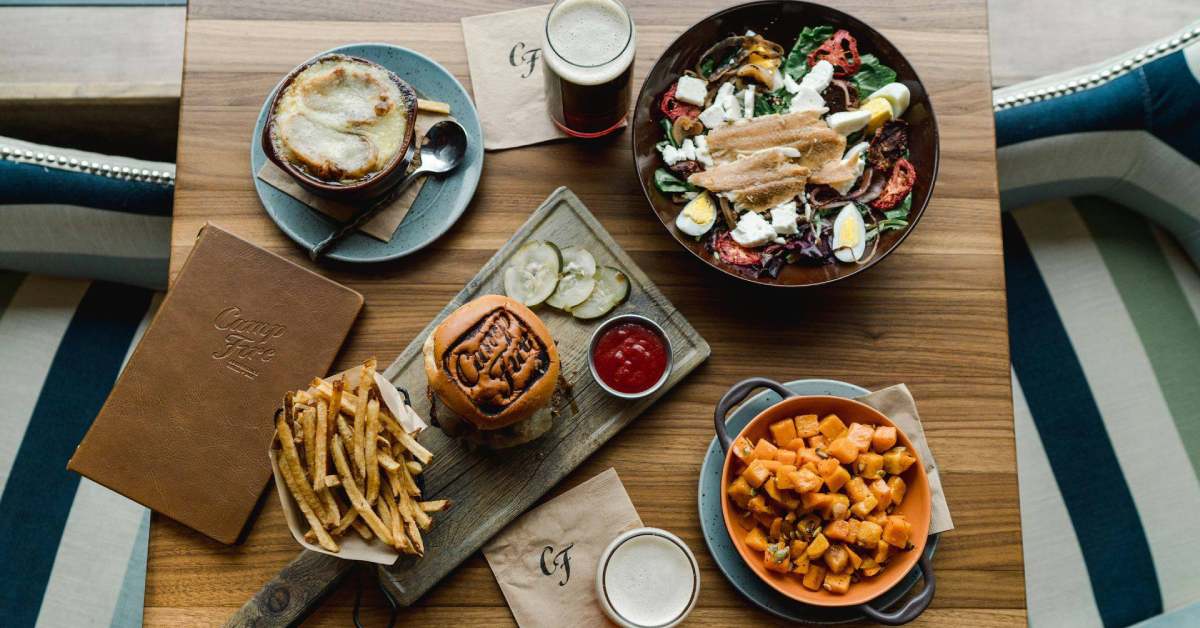 Overhead view of a table with various plates of food on it