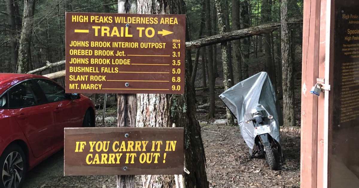 Close up of high peaks wilderness area trail sign with mile markers to each trail 