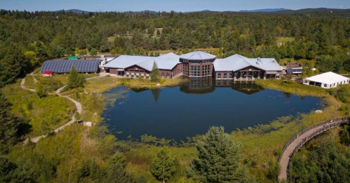 Aerial view of large building on a pond 