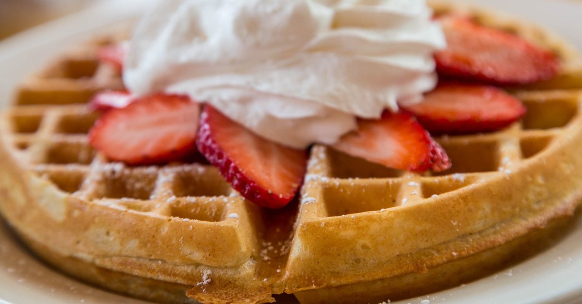 belgian waffle with strawberries and whipped cream