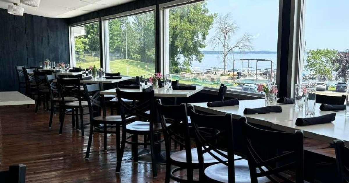 dining tables facing window offering a lake view