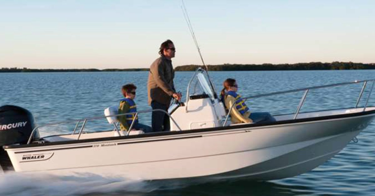 three people riding a fishing boat on the water