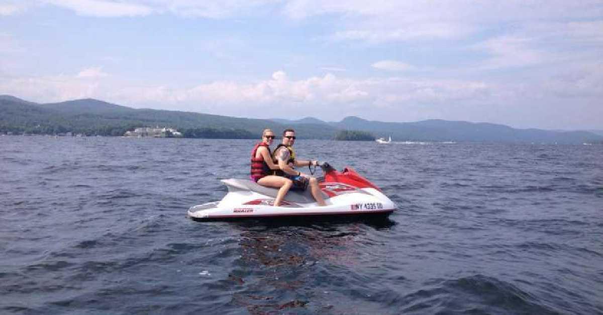 couple on jetski on the water smiling