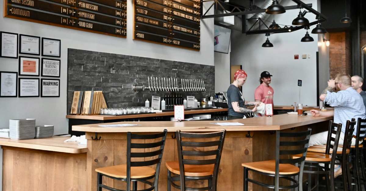 people seated at a brewery bar