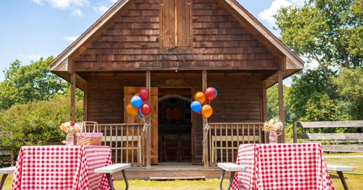 tables set up for birthday outside farm building