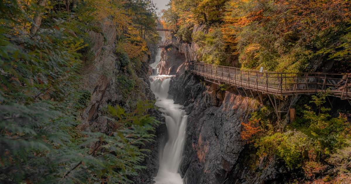 bridge walkway along waterfall in fall