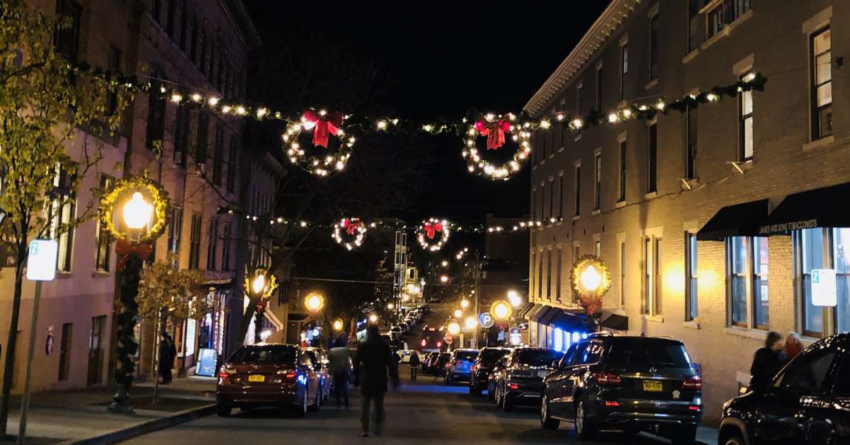 holiday wreaths hung above city street