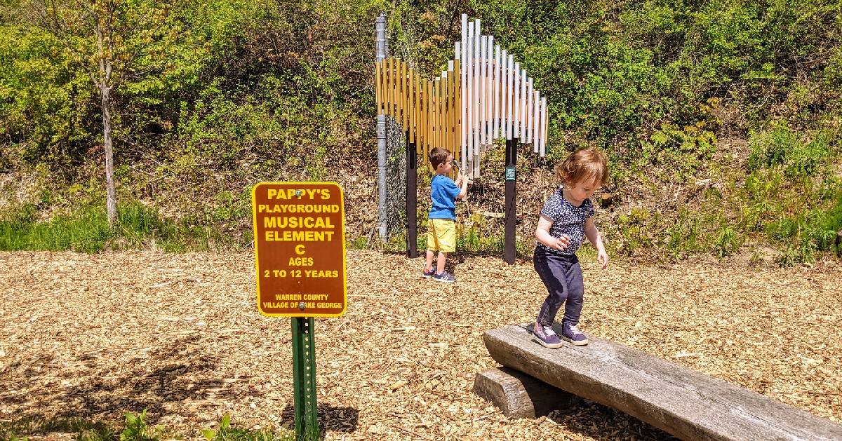 kids playing in a play area with a musical element