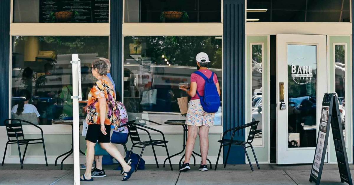 people walking outside a shopping plaza