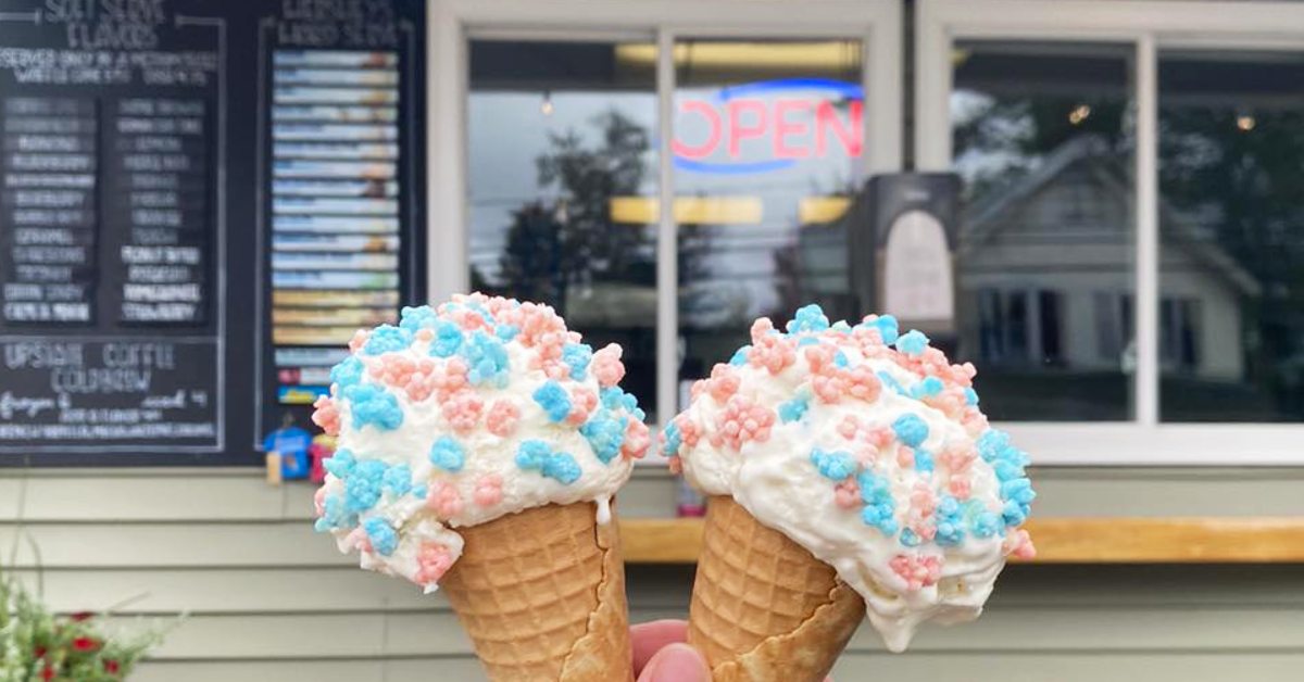 two pink and blue candy-topped ice cream cones side by side