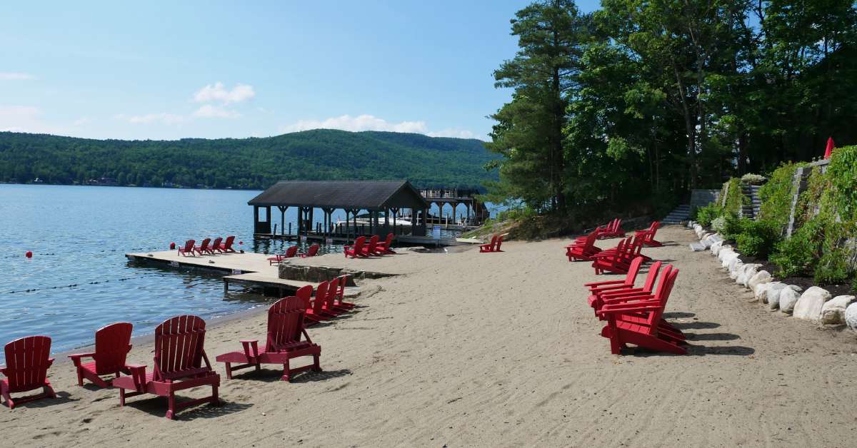 red lounge chairs on a sandy lake beach