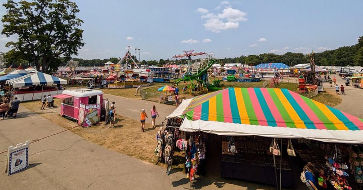 people walking around a county fair