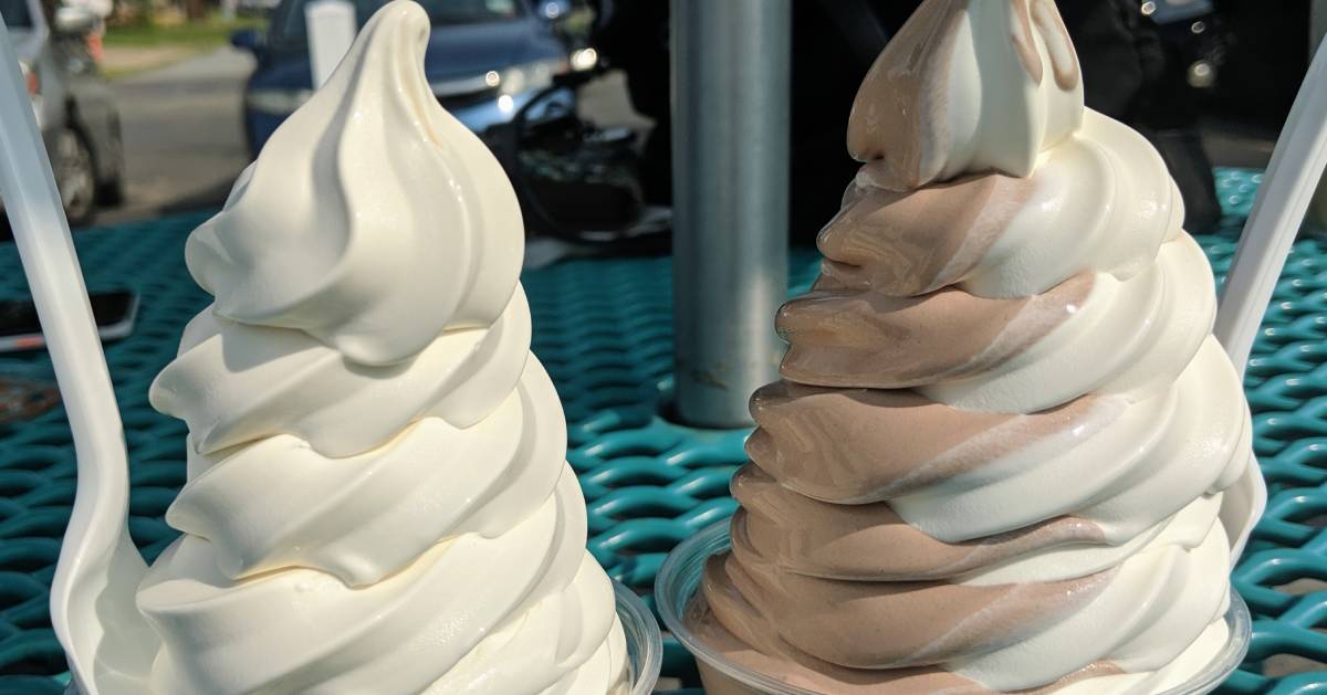 two soft serve ice cream dishes on a patio table