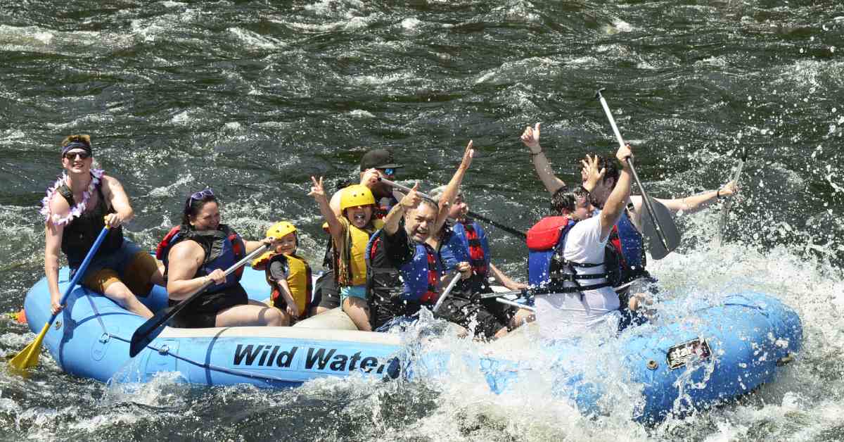 group of rafters posting for camera on the water