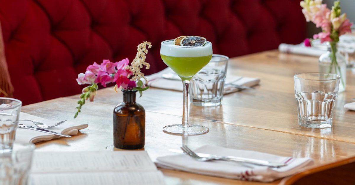 Green cocktail drink on decorated table