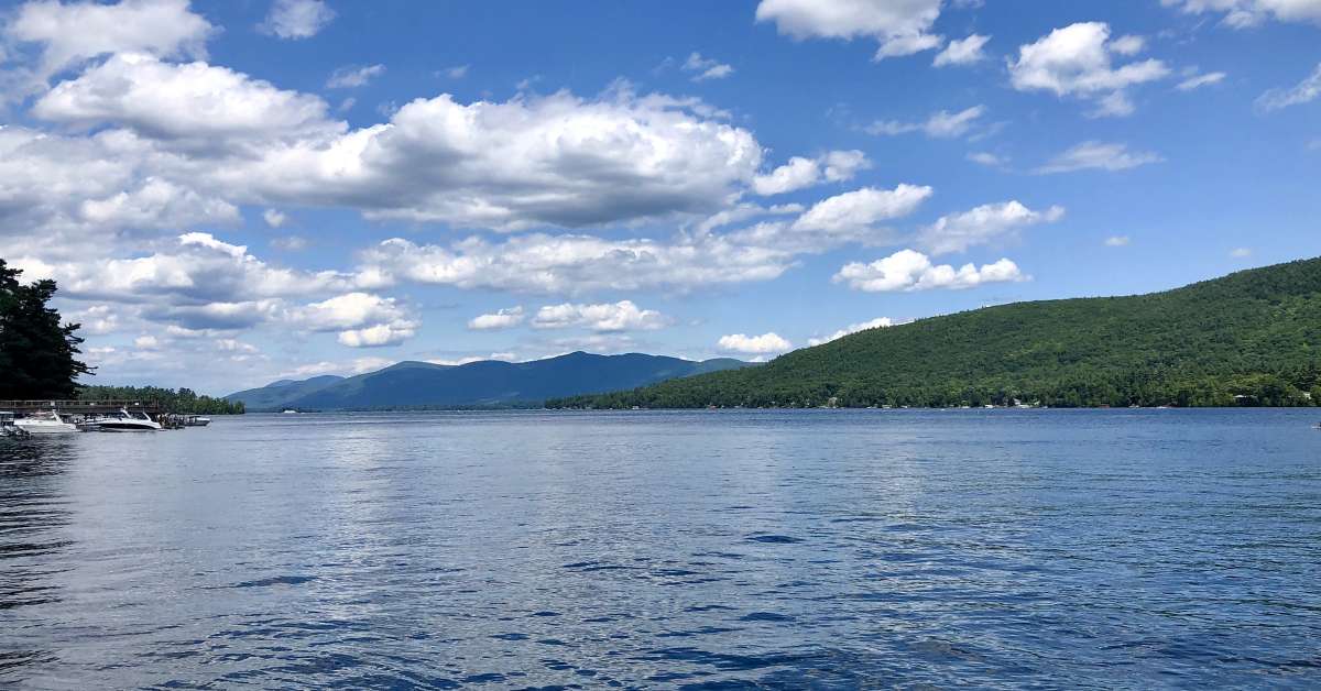 a lake with mountains in the back