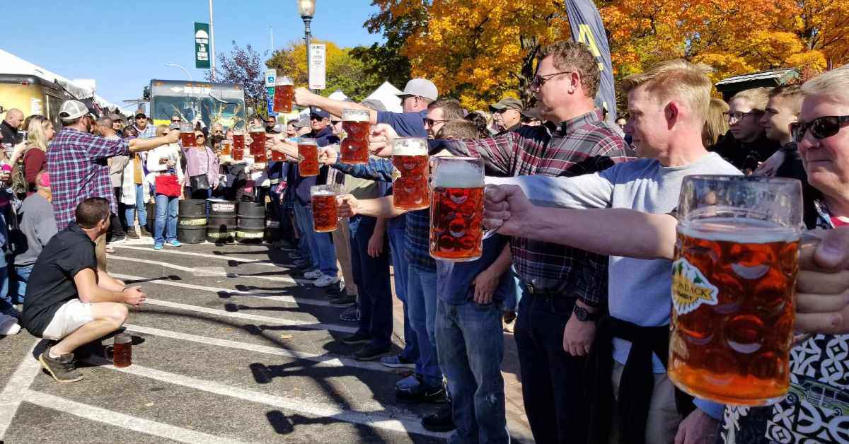 group of people lined up with beer in hand