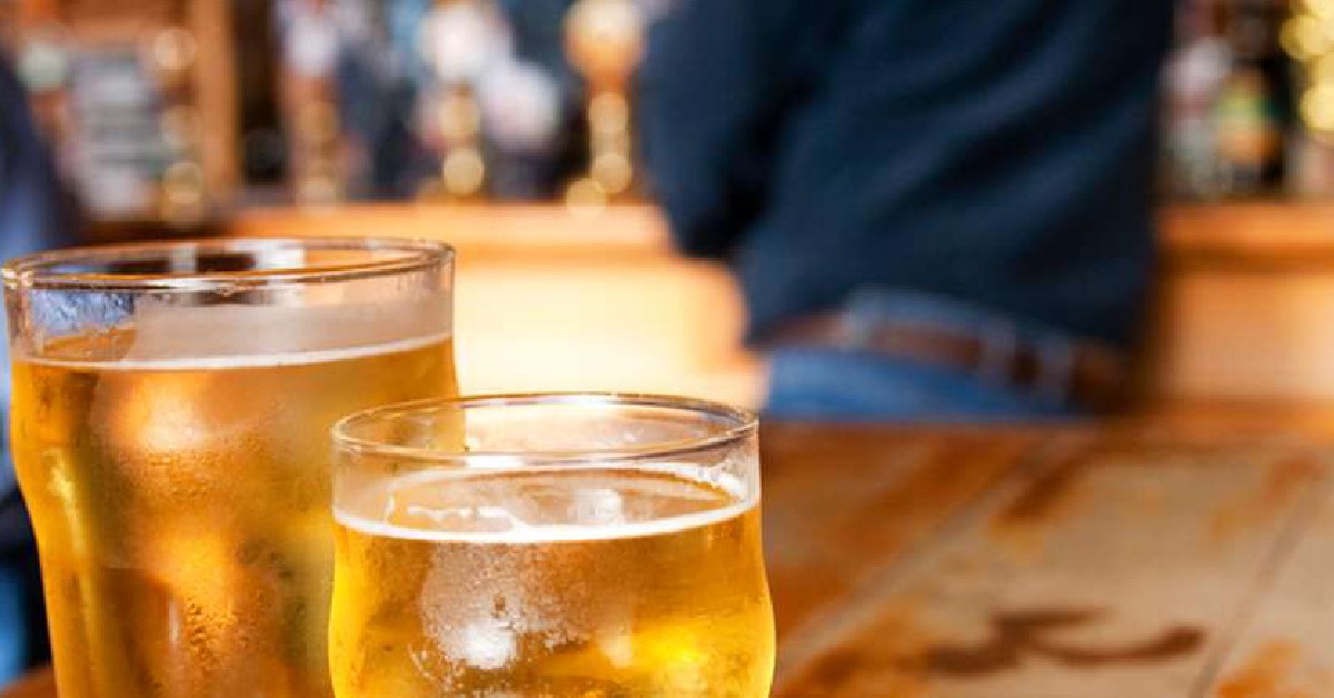 two glasses of beer with blurred background