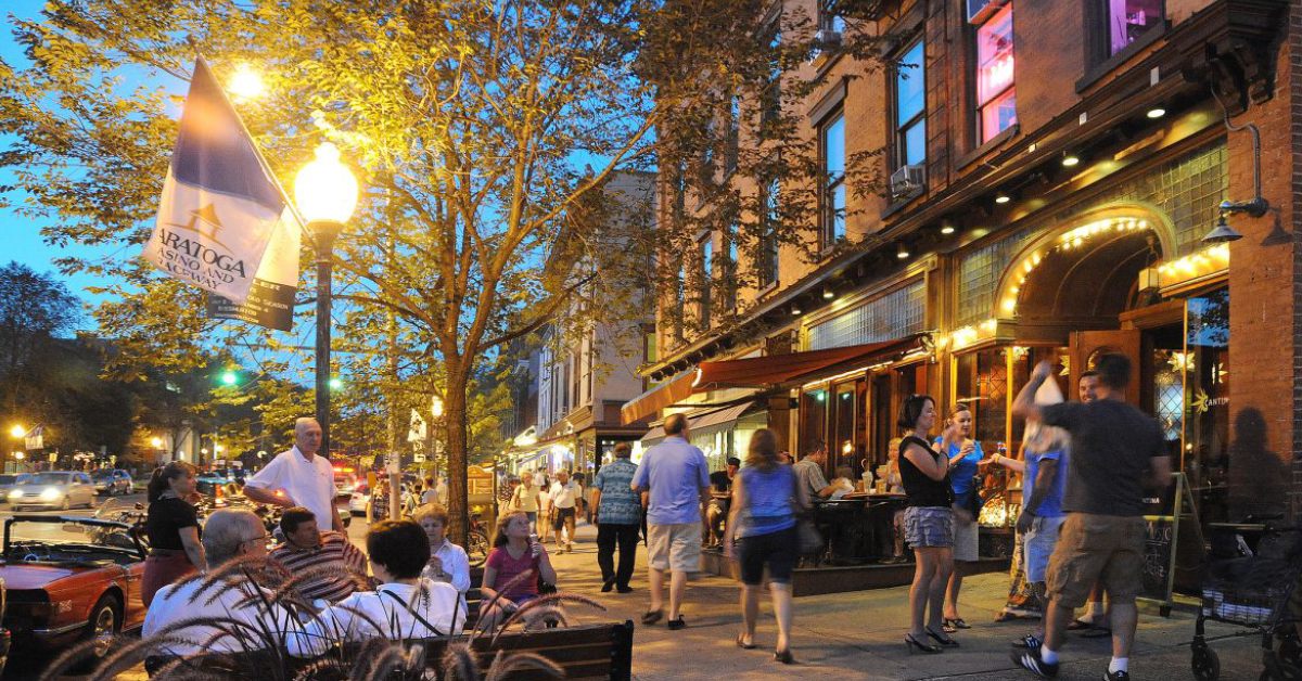 Downtown Saratoga at night with people walking