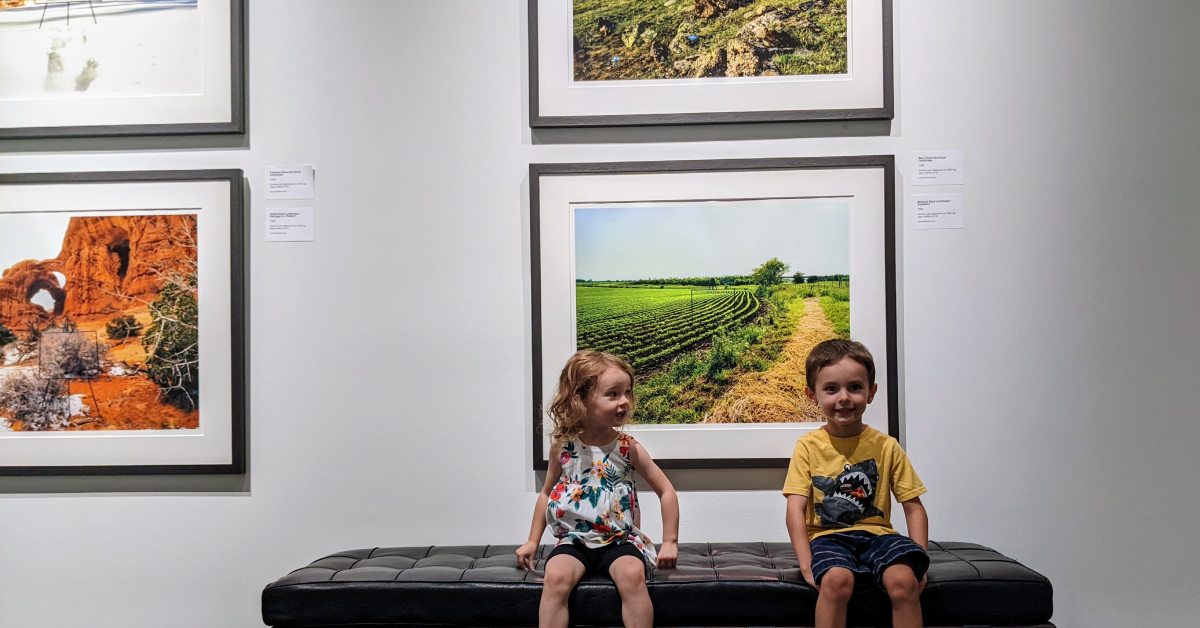 kids sit on bench by paintings at the hyde collection