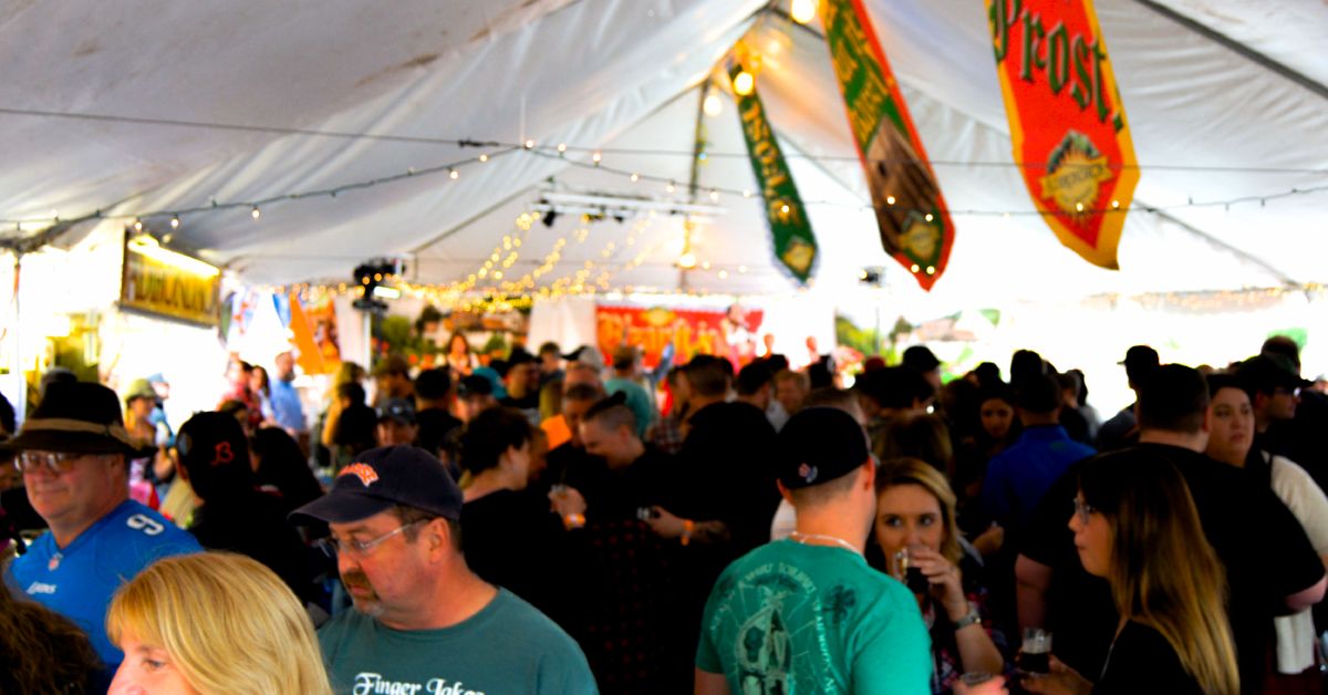 large group of people underneath tent 