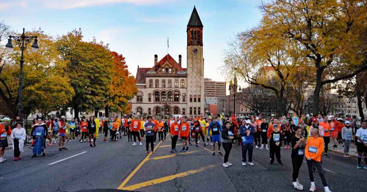 large group of people lining up for run on road