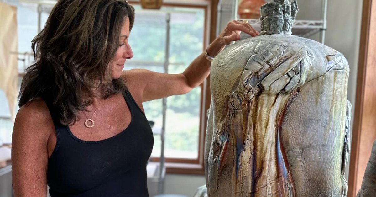 woman looks at sculpture at saratoga clay arts center