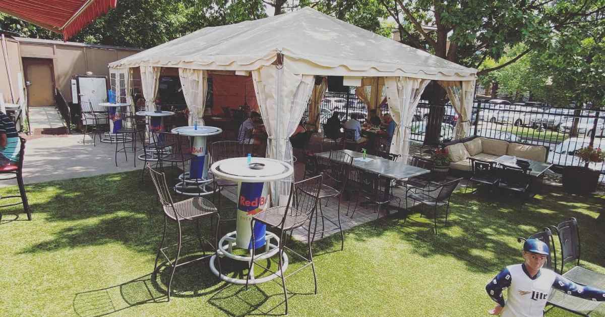 outdoor tent seating and tables at a bar