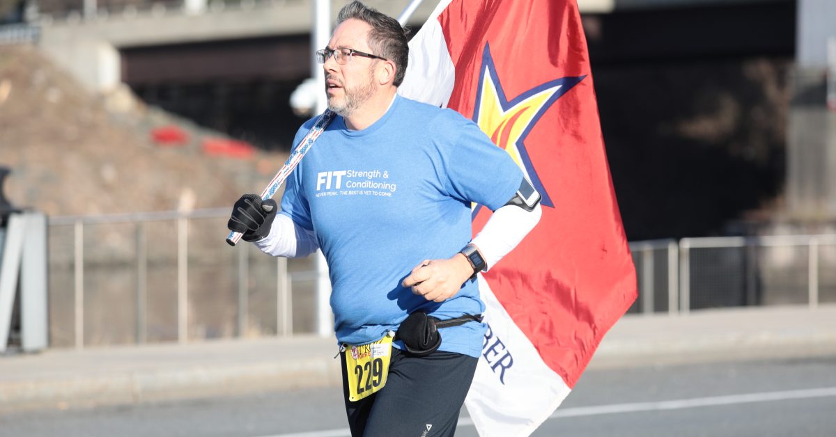 man holding flag while running in a race