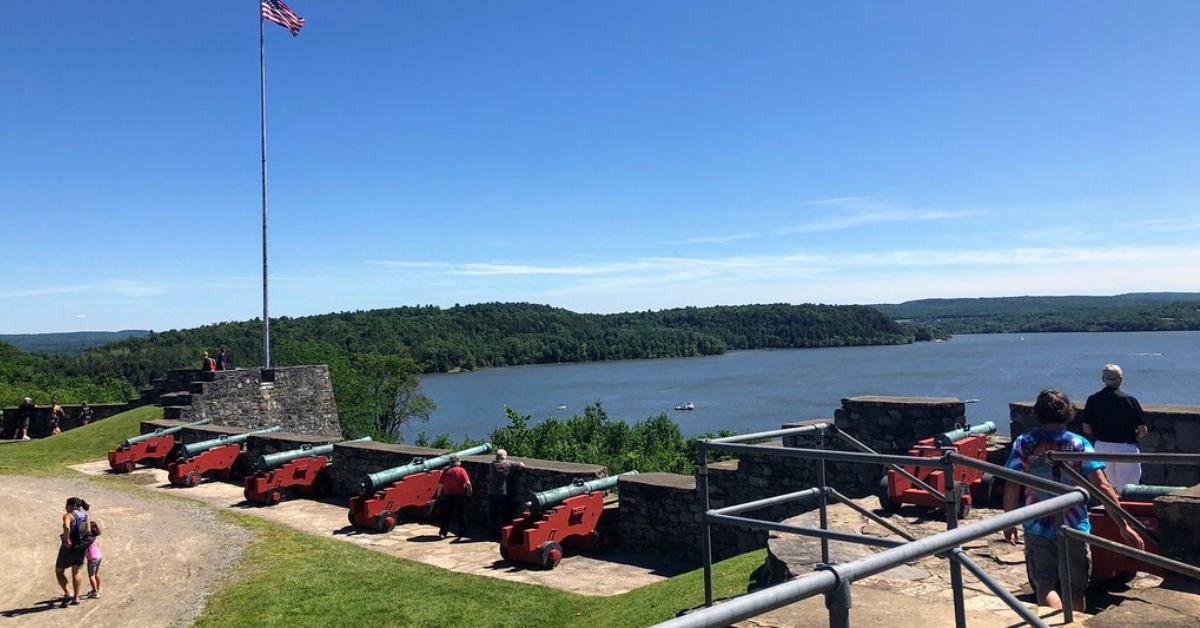 View of lake from on top of a fort with cannons and an american flag