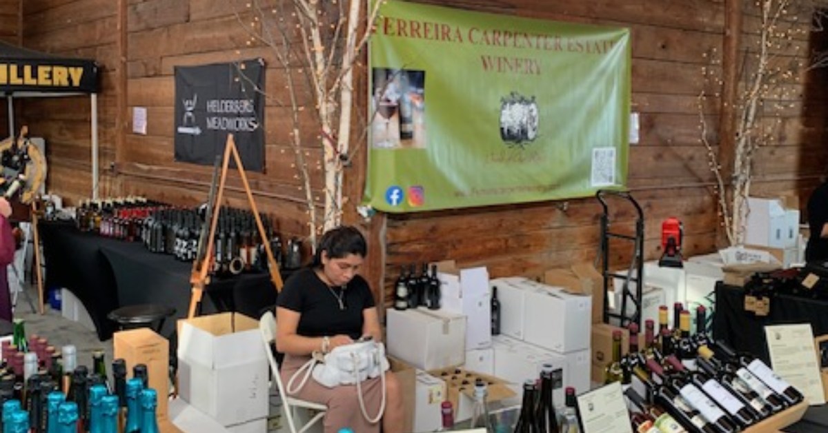 woman at a winery vendor table