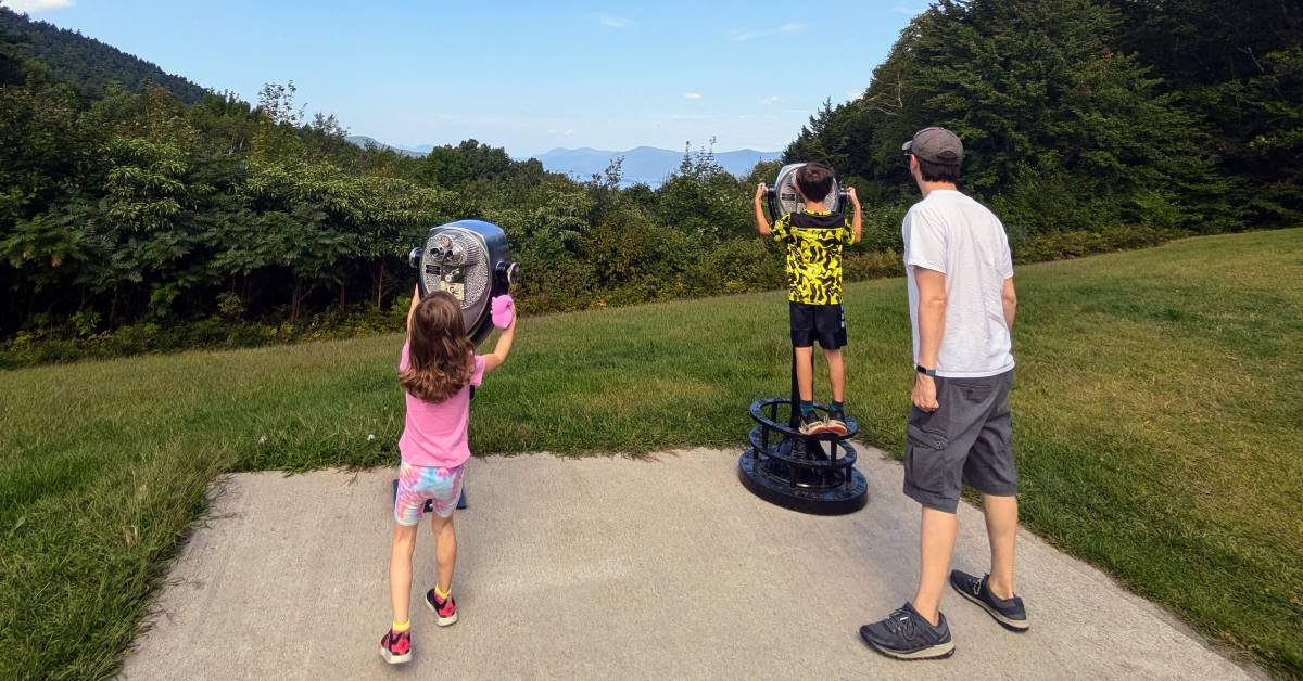 family looks through viewfinders at prospect mountain overlook