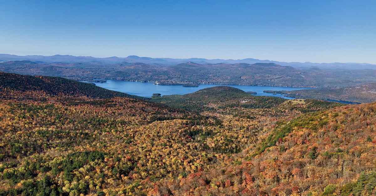 view of mountains with fall colors and a lake