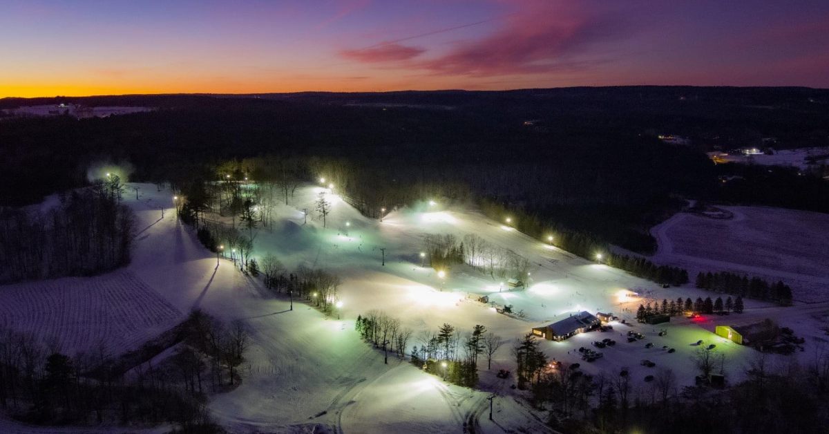 aerial view of a ski resort at night with lights