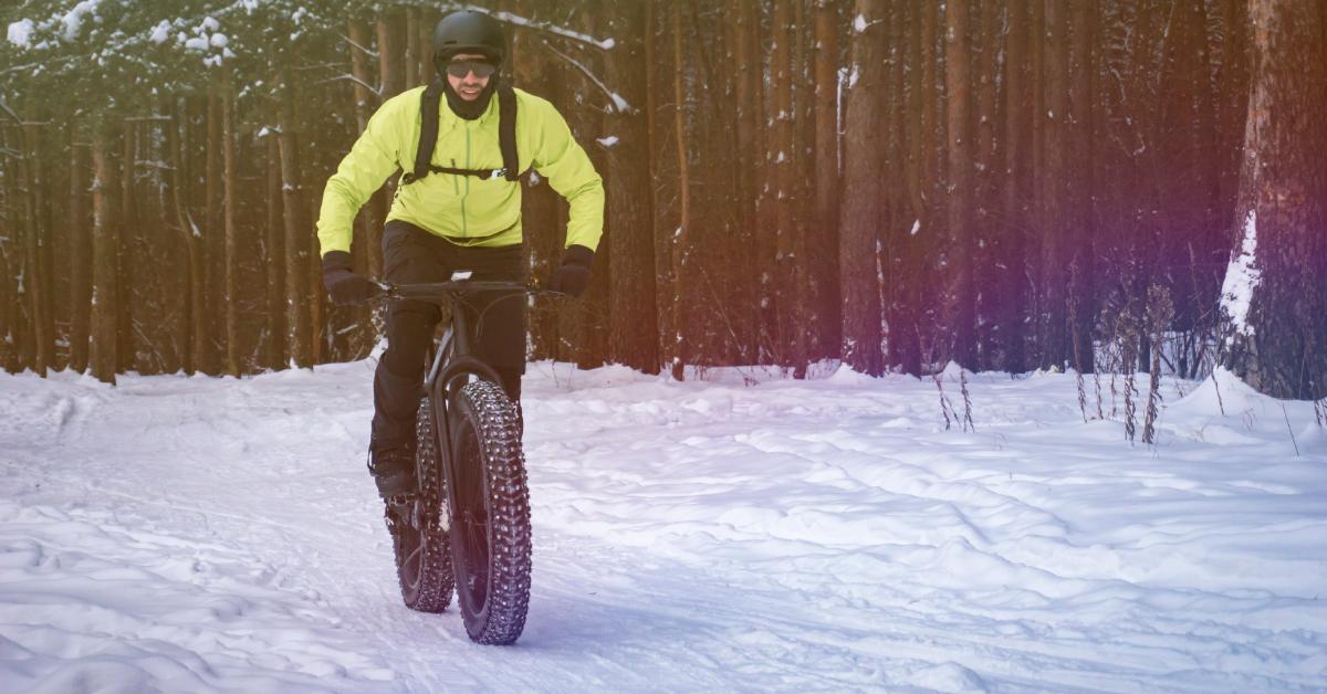 a fat tire biker in yellow jacket