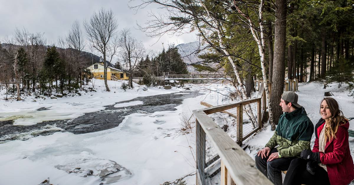 couple looks out at winter river