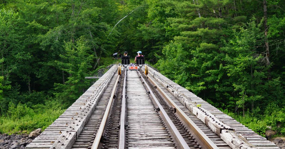 two people railbiking into the forest