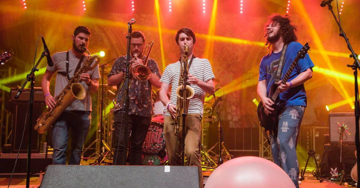 band performs on stage with four men