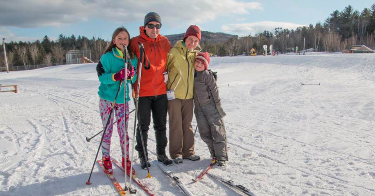 a family of four cross country skiers