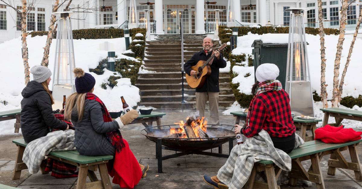 people listen to live music at sagamore ice bar by fire pit