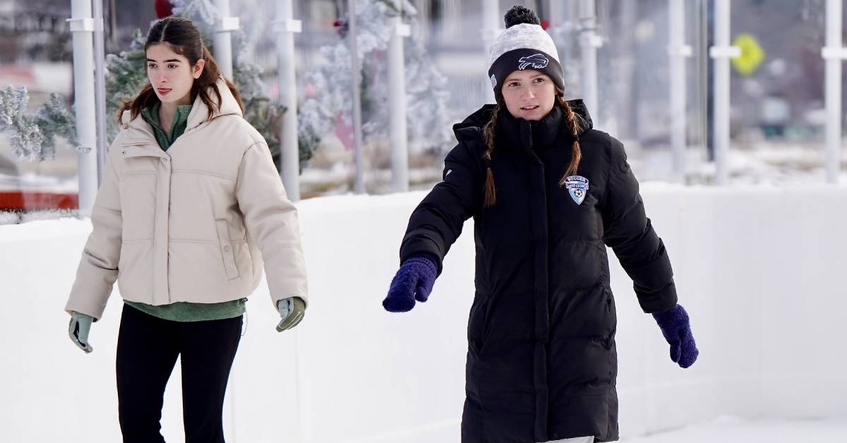 two teen girls ice skate