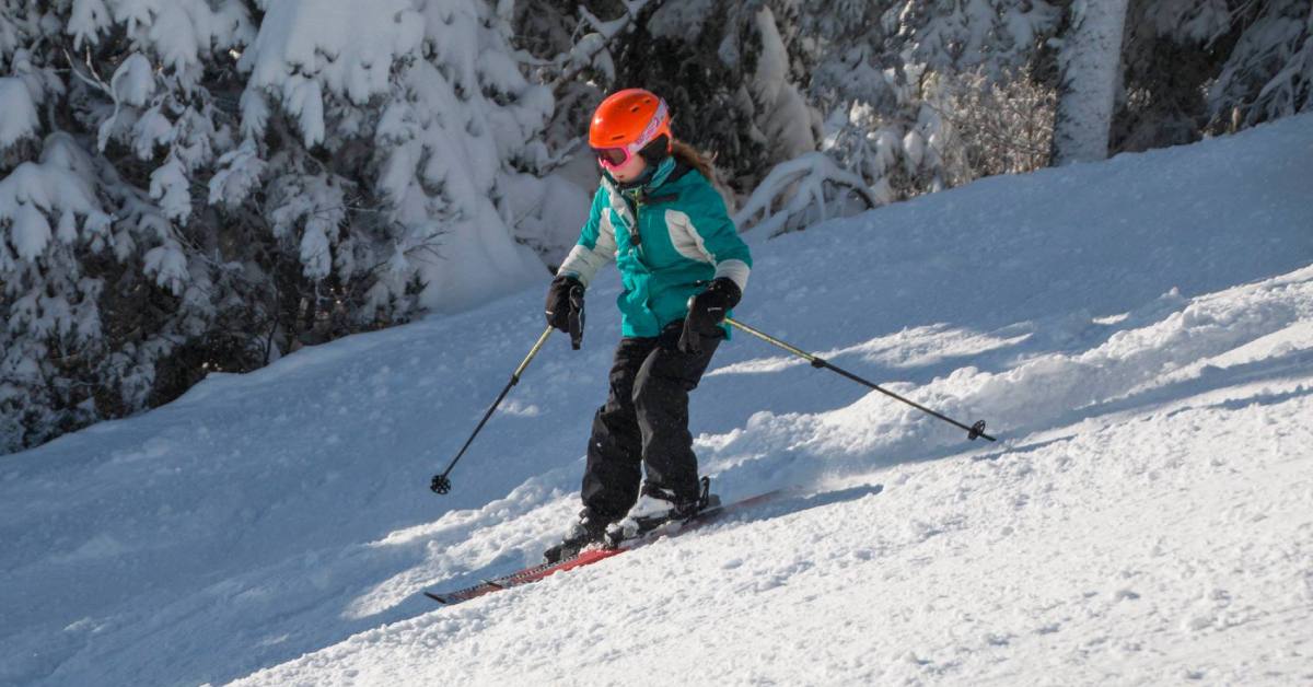 a kid downhill skiing