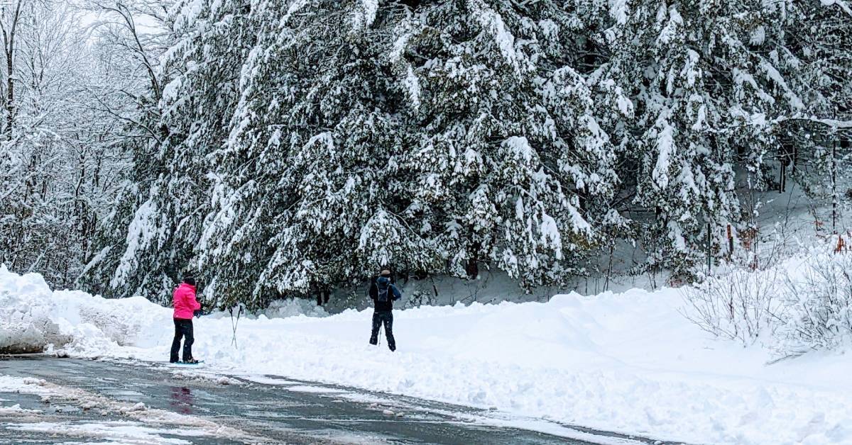 two adults going to snowshoe from gurney lane recreation center parking lot