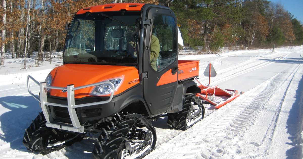 an orange ski trail groomer