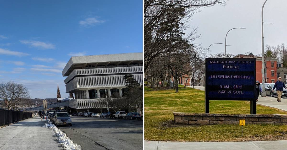 exterior of new york state museum and road on left, museum parking sign on right