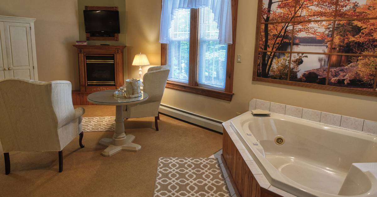 guest room with fireplace and hot tub