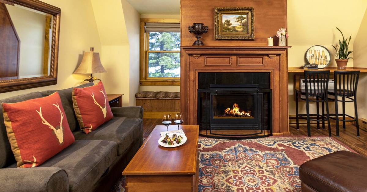 mirror lake inn room with fire in fireplace