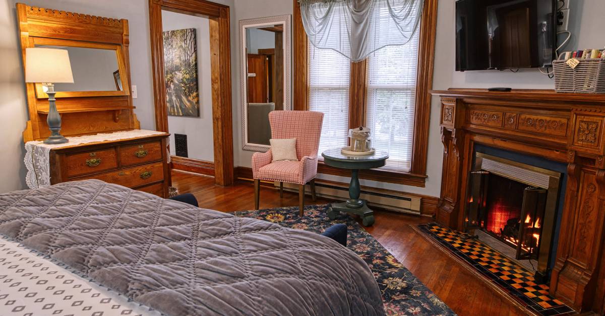 bedroom with fire in fireplace