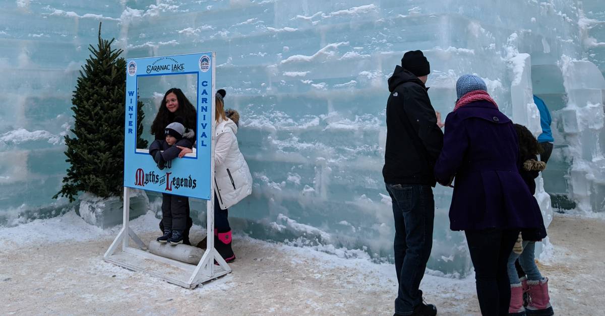 people pose for photo opp at saranac lake winter carnival